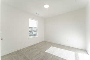 Carpeted empty room featuring baseboards