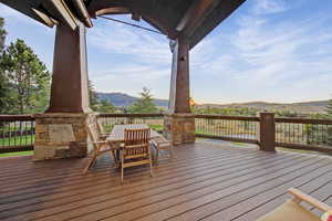 Wooden terrace with a mountain view and outdoor dining area