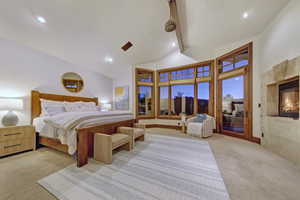Bedroom with light colored carpet, high vaulted ceiling, a tile fireplace, beamed ceiling, and recessed lighting