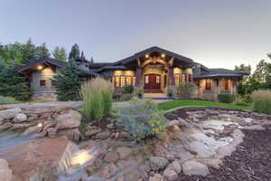 View of front of property featuring stone siding and a porch