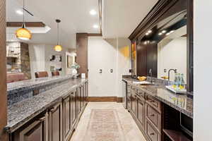 Bathroom with vanity, a tray ceiling, and recessed lighting