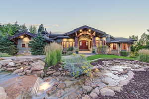 Craftsman-style home featuring stone siding and a porch