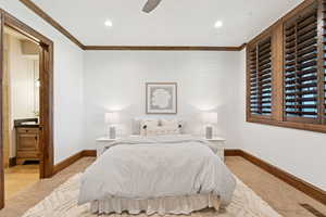 Bedroom with ornamental molding, carpet floors, a ceiling fan, recessed lighting, and ensuite bath