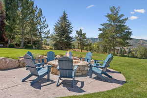 View of patio / terrace with an outdoor fire pit and a mountain view