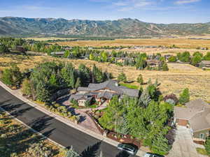 Aerial view of property and surrounding area with mountains
