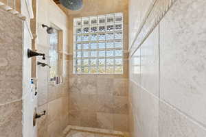 Full bathroom featuring a tile shower