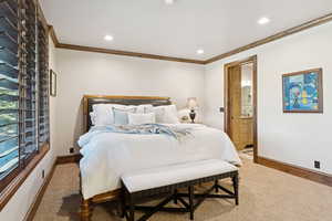 Bedroom with crown molding, recessed lighting, and connected bathroom