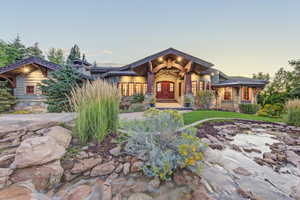 View of front of property featuring stone siding and a porch