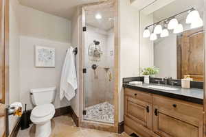 Bathroom featuring light tile patterned floors, vanity, and a stall shower