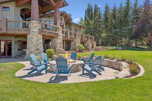 Patio / terrace with a patio area, a yard, and an outdoor fire pit