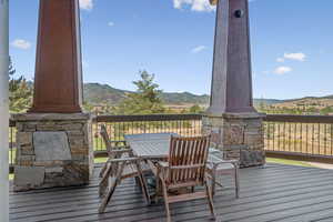 Deck featuring a mountain view and outdoor dining area