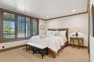Bedroom featuring ornamental molding, recessed lighting, and light colored carpet