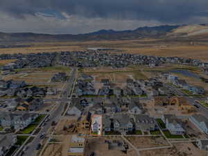 Aerial view of property's location with nearby suburban area and a mountain backdrop