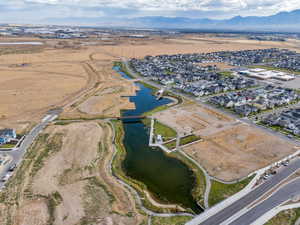 Aerial view of property's location featuring nearby suburban area and a water and mountain view