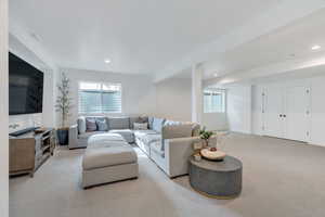 Living room featuring carpet floors, plenty of natural light, and recessed lighting