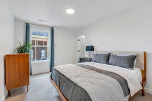 Carpeted bedroom featuring baseboards