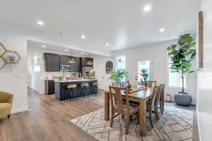 Dining space with recessed lighting and light wood-style floors