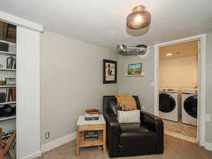 Sitting room featuring carpet flooring and separate washer and dryer