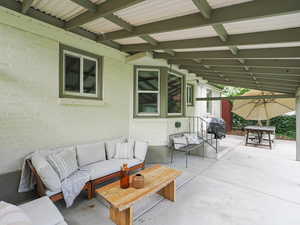 View of patio with a grill and an outdoor hangout area