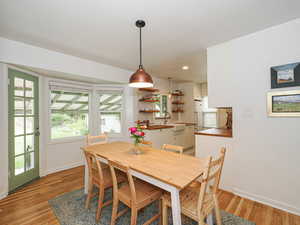 Dining space with light wood-style flooring and recessed lighting