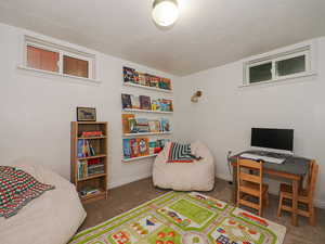 Bedroom featuring dark carpet and a textured ceiling