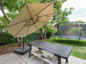 View of patio / terrace featuring outdoor dining space and a trampoline