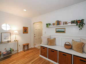 Mudroom with ornamental molding, arched walkways, light wood-style floors, and recessed lighting
