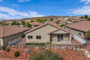 View of front of property featuring stucco siding, a residential view, and a fenced backyard