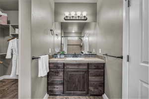 Bathroom featuring vanity and a tile shower