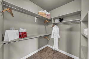 Walk in closet featuring dark tile patterned flooring
