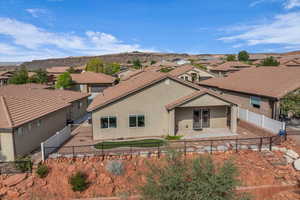 View of front facade with a residential view, a patio, stucco siding, and a fenced backyard