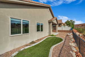 View of home's exterior with a patio, stucco siding, and a tile roof
