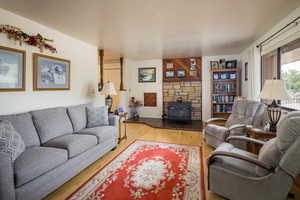 Living room featuring light wood-style flooring and a wood stove
