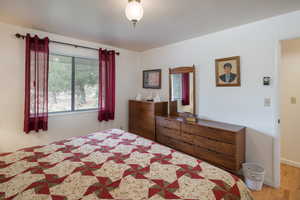 Bedroom featuring light wood-type flooring and baseboards