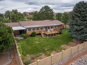 Back of house with a patio, stairs, a deck, brick siding, and a metal roof