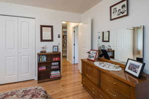 Bedroom with a closet and light wood-style floors