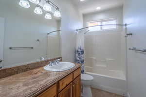 Full bath featuring shower / tub combo, vanity, and light tile patterned floors