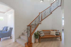 Stairs with arched walkways and wood finished floors