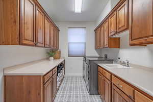 Laundry area with independent washer and dryer and cabinet space