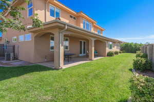 Rear view of house featuring a patio area and stucco siding