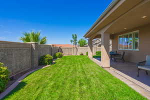 Fenced backyard featuring a patio