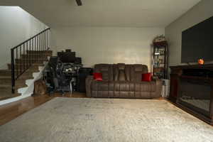 Living area with an office area, wood finished floors, and stairs