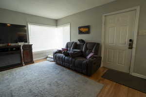 Living area featuring light wood-type flooring and baseboards
