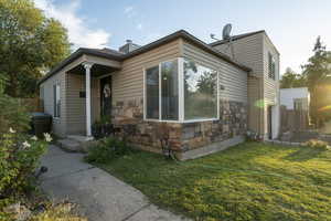 View of front facade featuring stone siding