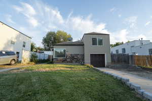 View of front of house with a garage, stone siding, and driveway