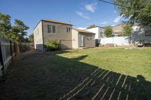 Back of house with a fenced backyard