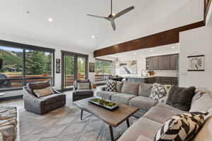 Living area with recessed lighting, a ceiling fan, light wood finished floors, french doors, and high vaulted ceiling