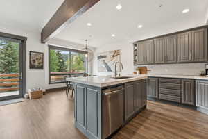 Kitchen with beam ceiling, backsplash, open shelves, dishwasher, and recessed lighting