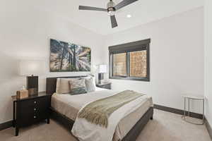 Bedroom featuring light carpet, a textured wall, a ceiling fan, and recessed lighting