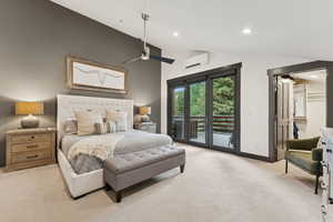Bedroom featuring vaulted ceiling, light carpet, access to exterior, recessed lighting, and a walk in closet